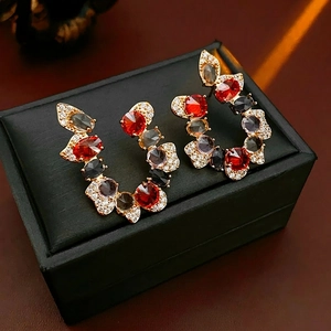 Vintage luxury U-shaped earrings with colorful zircon stones on a black jewelry box