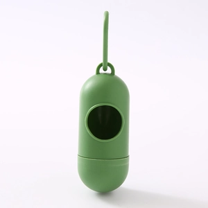 Detail of green capsule dog waste bag dispenser with hook on white background