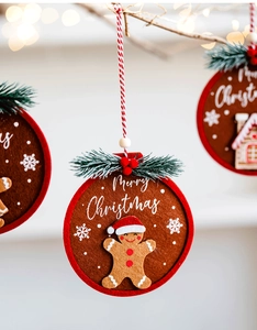 Close-up of felt gingerbread man Christmas ornament with Merry Christmas embroidery