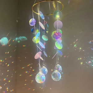 Rainbow suncatcher with iridescent discs and faceted crystal ball on golden metal ring