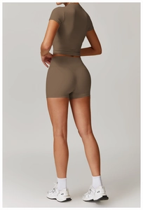 Rear view of brown high-waist yoga shorts and cropped tee showing premium fabric texture