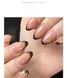 Detailed macro view of almond-shaped nails with French leopard print and gold lining