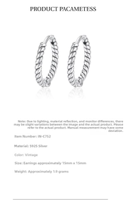 Macro detail of 925 sterling silver twisted hoop earrings with vintage oxidized finish
