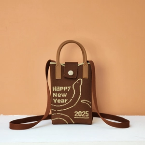 Detailed knit texture of brown crossbody bag with Happy New Year 2025 embroidery