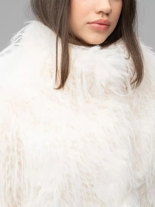 Close-up of white plush faux fur coat neckline showing thick premium feathery texture