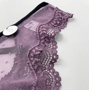 Close-up of purple lace mesh panties showing fabric texture and size S label