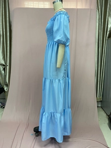 Detail of light blue off-shoulder floral maxi dress with smocked bodice and tiered skirt