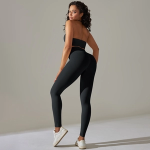 Detail of black ribbed yoga set featuring a halter neck top and high-waist leggings
