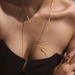 Artistic gold dancer pendant necklace on snake chain with a wide matching ring