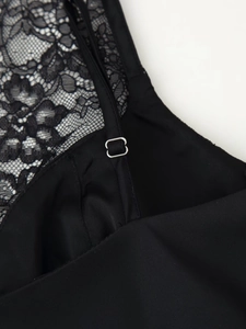 Detail of black lace and satin fabric with silver metal adjustable shoulder strap buckle