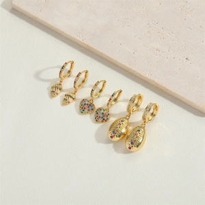Macro detail of French retro bow earrings with colorful zircon in gold plating