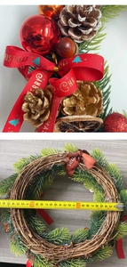 Detail of 25cm Christmas wreath with red ornaments, pine cones and measuring tape tool