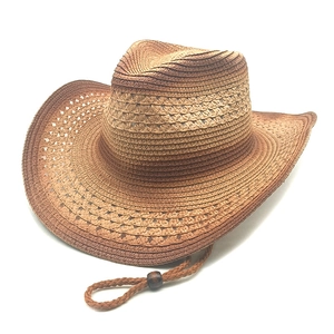 Detailed weave of brown straw cowboy hat with wood bead chin strap and hollow vents