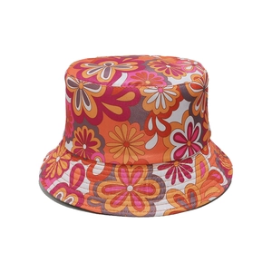 Detail of vintage floral bucket hat featuring vibrant 70s orange pattern on woven fabric