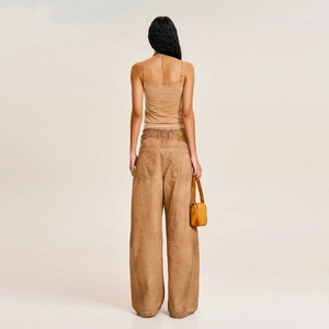 Back view of a cotton camisole and high-waisted wide-leg pants with a yellow leather handbag