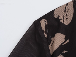 Detail of black mesh sleeve with brown abstract print and high-quality stitching
