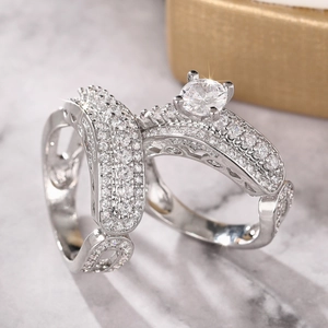 Macro shot of silver wedding ring set with sparkling zircon and four-prong setting