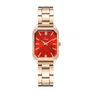 Detail of red dial with crystals and rose gold band on this luxury women's quartz watch
