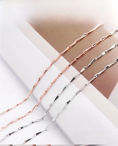 Detail of minimalist S925 sterling silver twisted bar chain in rose gold and silver