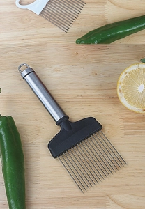 Macro view of stainless steel onion needle holder with black handle on wooden board