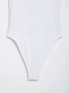 Detail of ribbed knit fabric texture and white bodysuit leg opening seam work