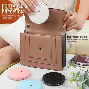 Mini portable LED light makeup mirror in four colors fitting into a handbag