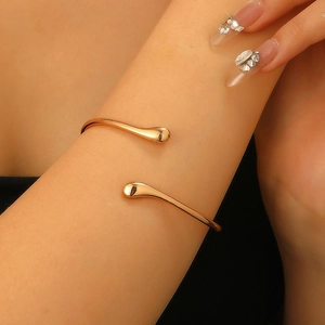 Minimalist rose gold liquid metal teardrop arm cuff with an adjustable open design