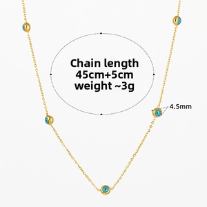 Detail view of gold eye necklace showing 4.5mm blue beads and 45cm plus 5cm chain length