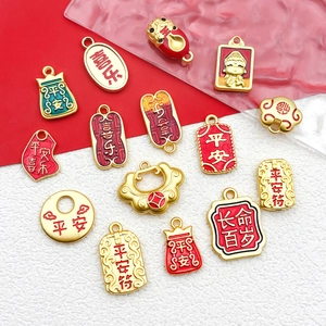 Detailed view of DIY alloy gold amulets and charms with traditional Chinese blessings