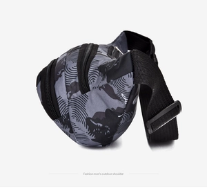 Detail view of water-resistant gray camouflage fabric and durable nylon buckle on waist bag