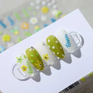 Floral nail art stickers with small yellow flowers and green leaves on white base