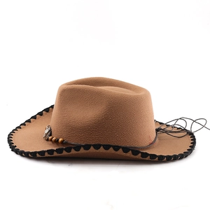 Detail of brown cowboy hat with braided cord, wooden beads and silver metal ornament