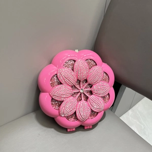 Detailed view of 3D pink flower evening clutch bag with sparkling rhinestone embellishments