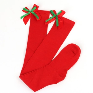 Detail view of red Christmas over-knee socks featuring festive red and green ribbon bows