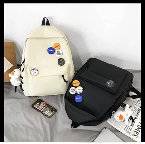 Japanese style large capacity backpacks in beige and black with cute duck pendant and badges