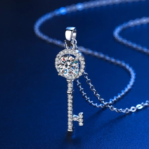 Detailed macro view of a silver key pendant necklace with a brilliant round central zircon