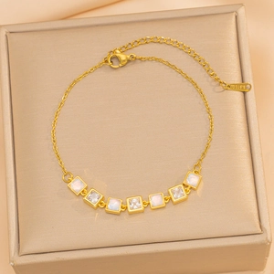 Elegant gold stainless steel bracelet with square cat-eye stones and clear zircons