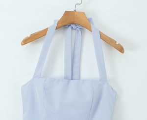 Close-up detail of blue and white striped halter dress with neck tie and side zipper