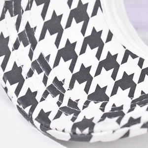 Close-up of the meticulous houndstooth pattern and stitching on the baseball cap brim