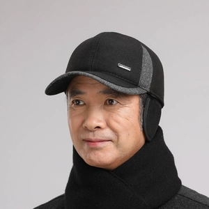Close-up of men's winter baseball cap with ear flaps and sports metal logo detail