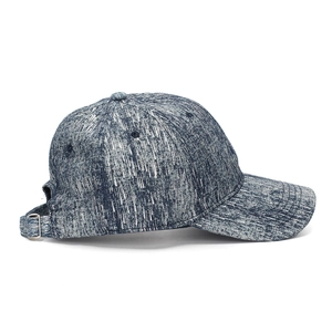 Detail of blue denim baseball cap showing rear adjustable metal buckle and textured fabric