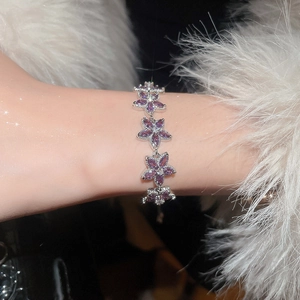 Close-up of sparkling floral bracelet with purple marquise zircons on silver chain