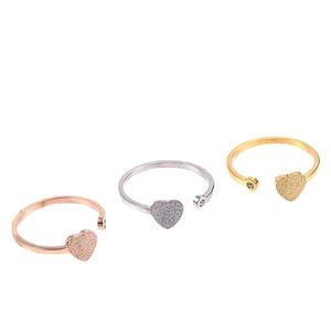 Three minimalist stainless steel open heart rings in rose gold, silver and gold finishes