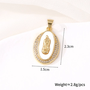 Detailed macro view of gold-plated oval Virgin Mary pendant with white zircon stones
