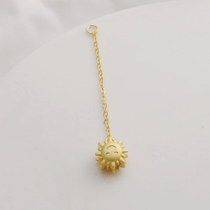 Detailed view of matte 18K gold sun smiley face pendant with O-chain extender