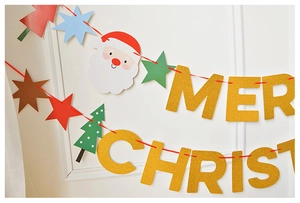 Close-up of Merry Christmas glitter banner with Santa, star, and tree festive elements