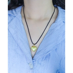 Elegant S925 silver heart pendant on adjustable black rope worn by a model