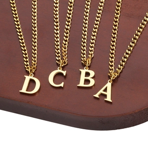 Minimalist 18K gold plated stainless steel initial pendant necklaces on wood tray