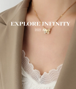 Close-up of golden butterfly pendant with sparkling zircons on elegant fine chain