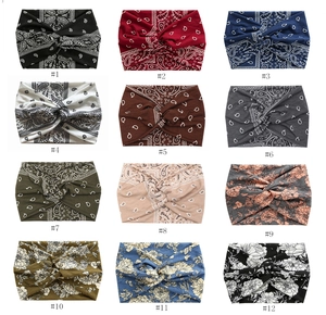 Collage of 12 bohemian wide knotted headbands featuring paisley and floral prints